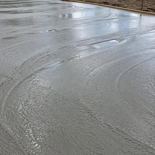 Bull float marks on fresh wet concrete during concrete floor installation