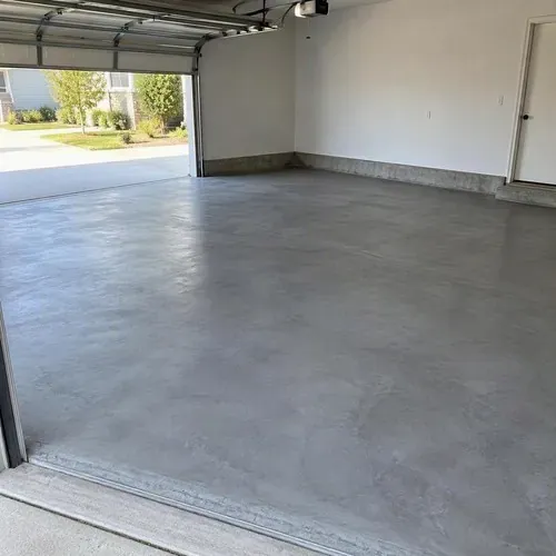 Finished smooth gray concrete floor in garage after concrete floor installation