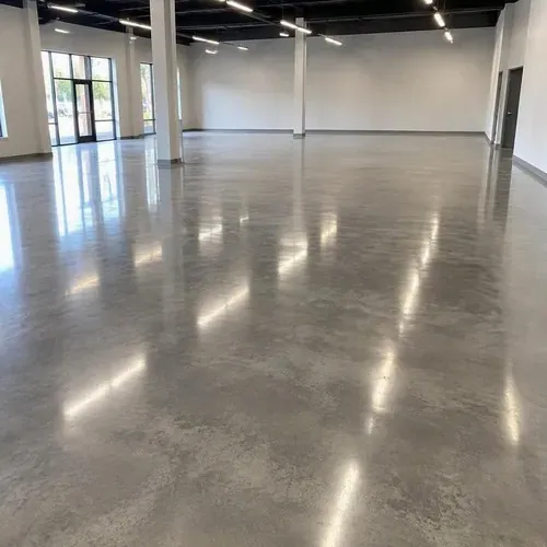 Glossy polished concrete reflecting lights in showroom after concrete polishing and coating