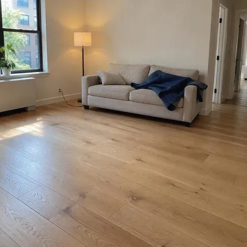 Finished wide-plank white oak engineered floor after engineered hardwood installation