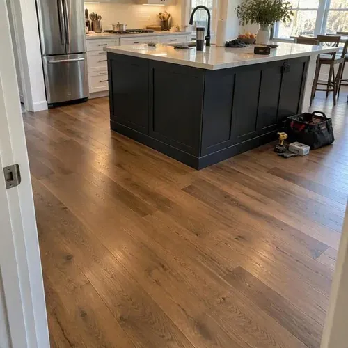 Engineered hardwood fitted around kitchen island during engineered hardwood installation