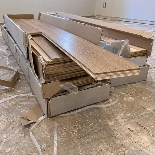 Opened engineered hardwood boxes showing layered plank edges during engineered hardwood installation