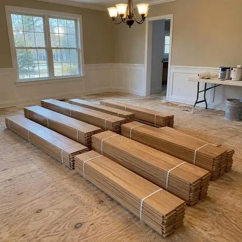 Solid oak flooring bundles acclimating in dining room during hardwood floor installation