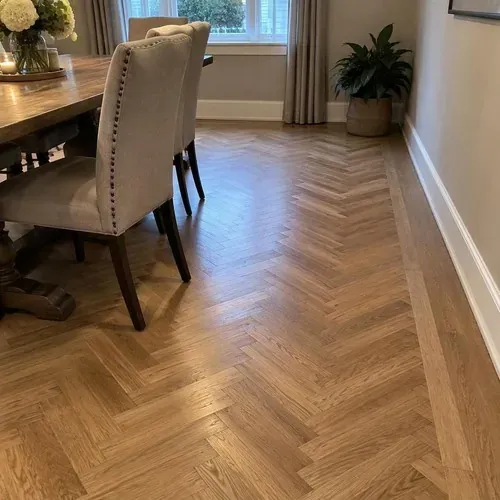 Finished herringbone floor with border in dining room after herringbone and parquet floor installation