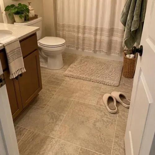 Finished heated tile bathroom floor with bathmat after radiant heated floor installation