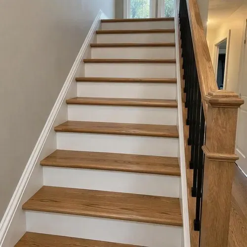 Finished oak treads with white painted risers after stair and railing installation