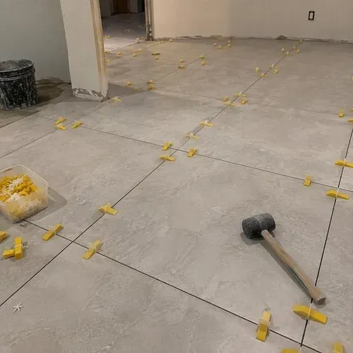 Large porcelain tiles with leveling clips, ungrouted during ceramic and porcelain tile installation