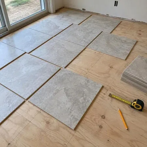 Tile layout dry-fit with pencil lines on subfloor during ceramic and porcelain tile installation